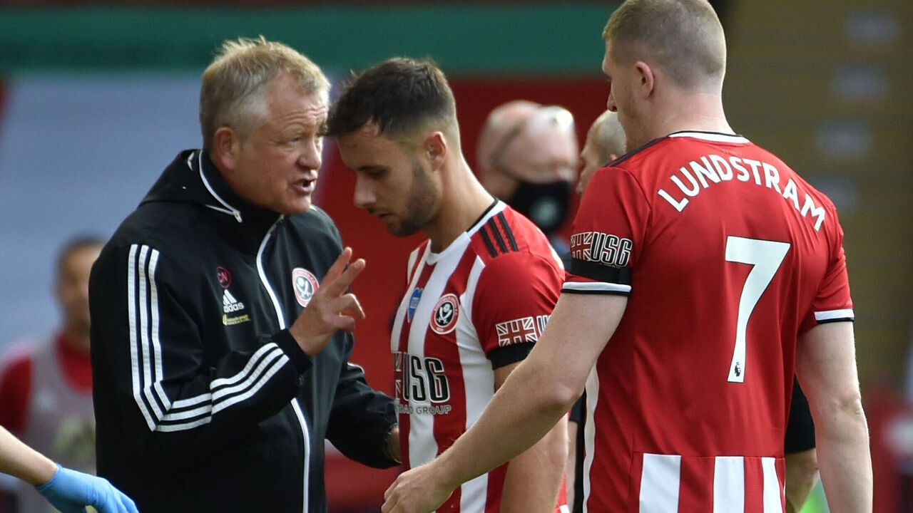 SHEFFIELD, ENGLAND - JULY 11: Chris Wilder, Manager of Sheffield United speaks with George Baldock of Sheffield United during a drinks break in the Premier League match between Sheffield United and Chelsea FC at Bramall Lane on July 11, 2020 in Sheffield, England. Football Stadiums around Europe remain empty due to the Coronavirus Pandemic as Government social distancing laws prohibit fans inside venues resulting in all fixtures being played behind closed doors.