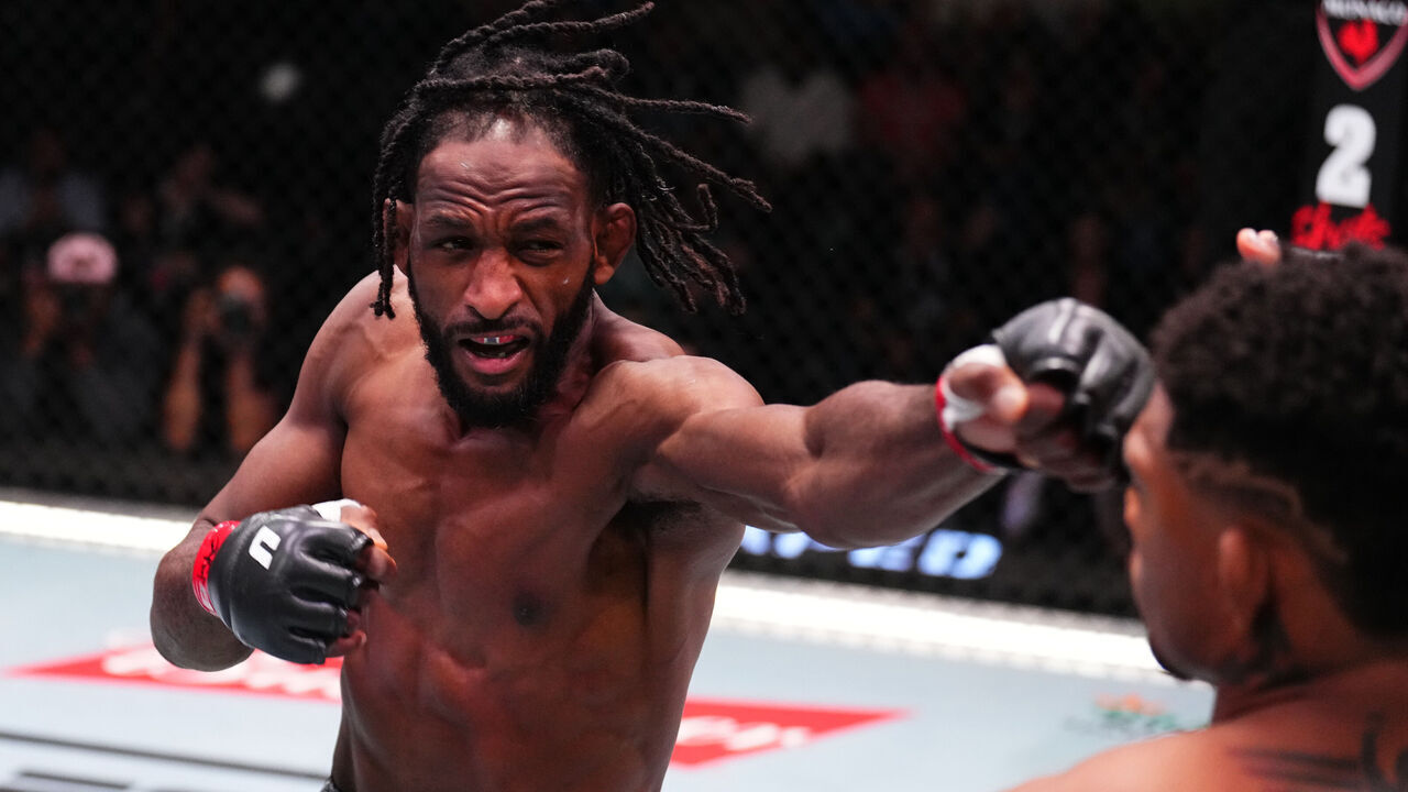 LAS VEGAS, NEVADA - AUGUST 24: Neil Magny punches Michael Morales of Ecuador in a welterweight fight during the UFC Fight Night event at UFC APEX on August 24, 2024 in Las Vegas, Nevada.