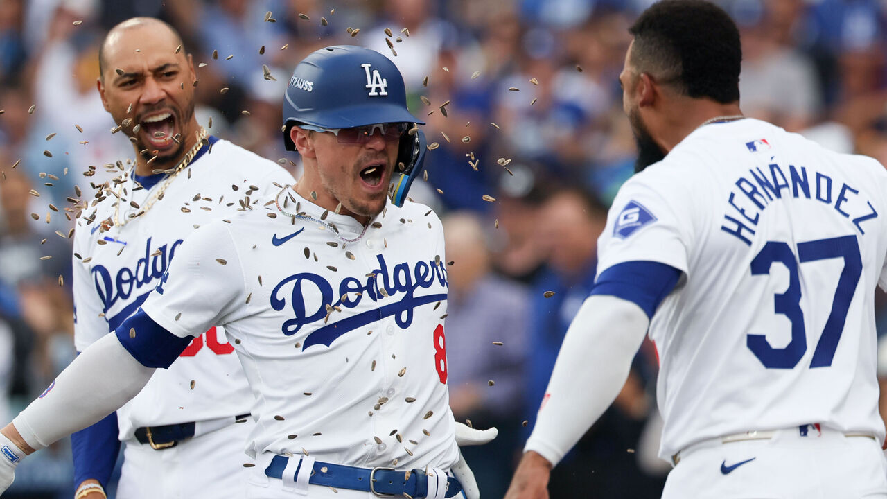 LOS ANGELES, CALIFORNIA - OCTOBER 11: Teoscar Hernandez #37 of the Los Angeles Dodgers celebrates a solo home run by Enrique Hernandez #8 of the Los Angeles Dodgers by throwing sunflower seeds on Enrique during the second inning in game five of the National League Division Series against the San Diego Padres at Dodger Stadium on Friday, Oct. 11, 2024 in Los Angeles. (Robert Gauthier / Los Angeles Times via Getty Images)