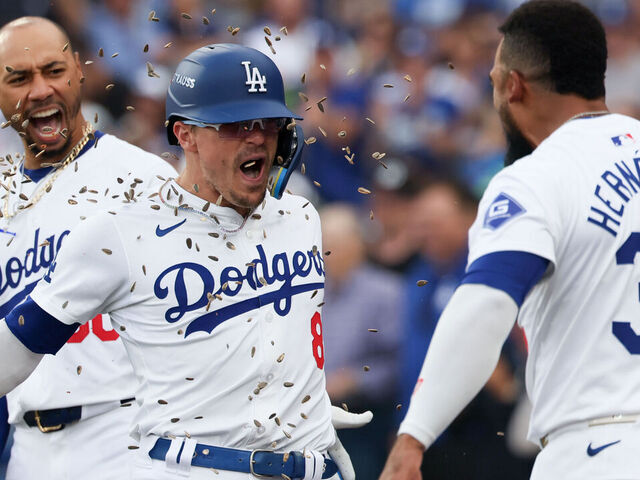 LOS ANGELES, CALIFORNIA - OCTOBER 11: Teoscar Hernandez #37 of the Los Angeles Dodgers celebrates a solo home run by Enrique Hernandez #8 of the Los Angeles Dodgers by throwing sunflower seeds on Enrique during the second inning in game five of the National League Division Series against the San Diego Padres at Dodger Stadium on Friday, Oct. 11, 2024 in Los Angeles. (Robert Gauthier / Los Angeles Times via Getty Images)