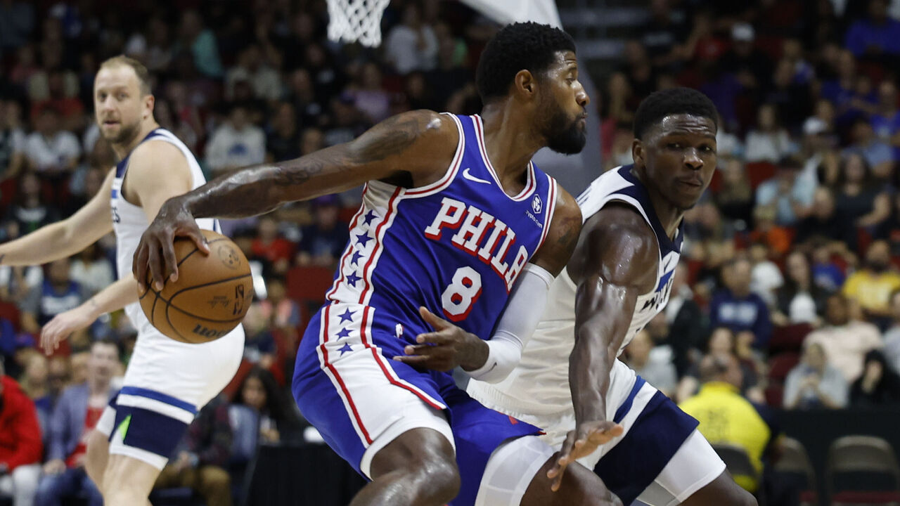DES MOINES, IOWA - OCTOBER 11: Paul George #8 of the Philadelphia 76ers drives the ball as Anthony Edwards #5 of the Minnesota Timberwolves puts pressure on him in the first half of play during a preseason game at Wells Fargo Arena on October 11, 2024, in Des Moines, Iowa.