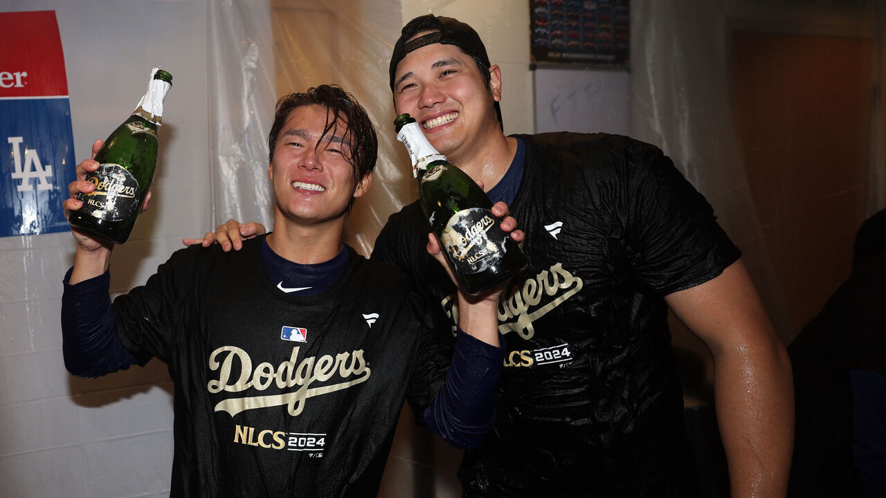 LOS ANGELES, CALIFORNIA - OCTOBER 11: Yoshinobu Yamamoto (L) and Shohei Ohtani (R) of the Los Angeles Dodgers celebrate in the locker room after defeating the San Diego Padres in Game Five to win the Division Series at Dodger Stadium on October 11, 2024 in Los Angeles, California.