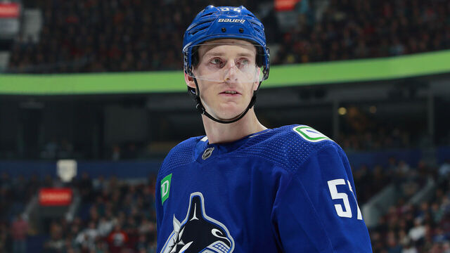 VANCOUVER, CANADA - FEBRUARY 18: Tyler Myers #57 of the Vancouver Canucks looks on from the bench during their NHL game against the Philadelphia Flyers at Rogers Arena February 18, 2023 in Vancouver, British Columbia, Canada.