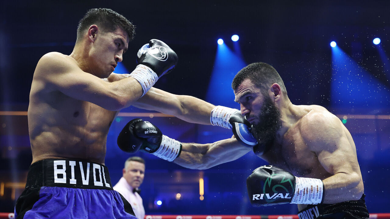 RIYADH, SAUDI ARABIA - OCTOBER 12: Dmitrii Bivol punches Artur Beterbiev during the IBF, IBO, WBC and WBO World Light Heavyweight titles' fight between Artur Beterbiev and Dmitrii Bivol as part of the Riyadh Season - IV Crown Showdown card at Kingdom Arena on October 12, 2024 in Riyadh.