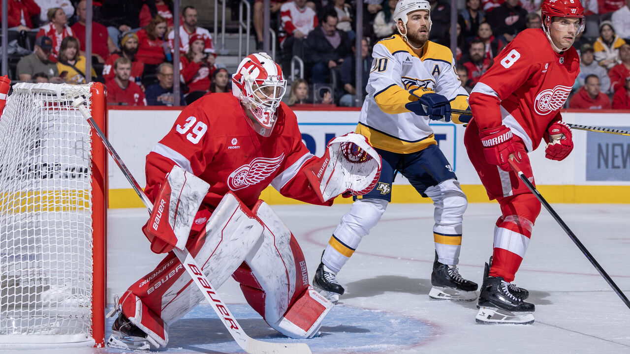 DETROIT, MICHIGAN - OCTOBER 12: Cam Talbot #39 of the Detroit Red Wings follows the play next to Ben Chiarot #8 and Ryan O'Reilly #90 of the Nashville Predators during the second period at Little Caesars Arena on October 12, 2024 in Detroit, Michigan.