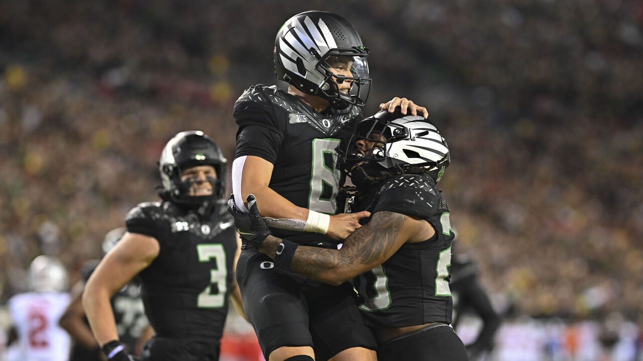 EUGENE, OREGON - OCTOBER 12: Dillon Gabriel #8 of the Oregon Ducks celebrates with teammates after running for a touchdown during the fourth quarter of the game against the Ohio State Buckeyes at Autzen Stadium on October 12, 2024 in Eugene, Oregon.