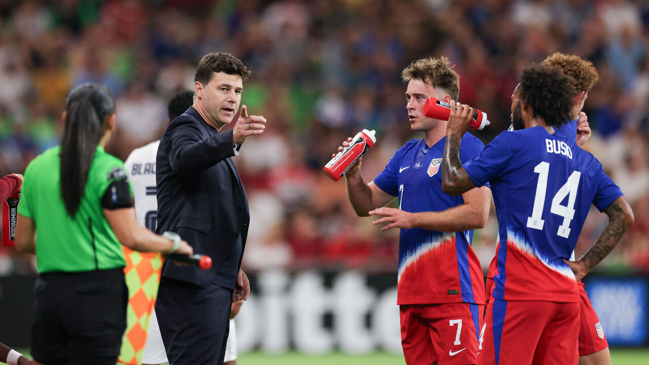 AUSTIN, TEXAS - OCTOBER 12: United States head coach Mauricio Pochettino talks with Aidan Morris #7 and Gianluca Busio #14 during the second half against p at Q2 Stadium on October 12, 2024 in Austin, Texas.
