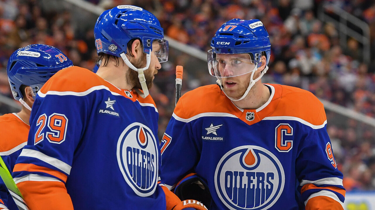 EDMONTON, CANADA - OCTOBER 12: Leon Draisaitl #29, Connor McDavid #97 and Viktor Arvidsson #33 of the Edmonton Oilers have a conversation during a stoppage in play in the second period of the game against the Chicago Blackhawks at Rogers Place on October 12, 2024, in Edmonton, Alberta, Canada.