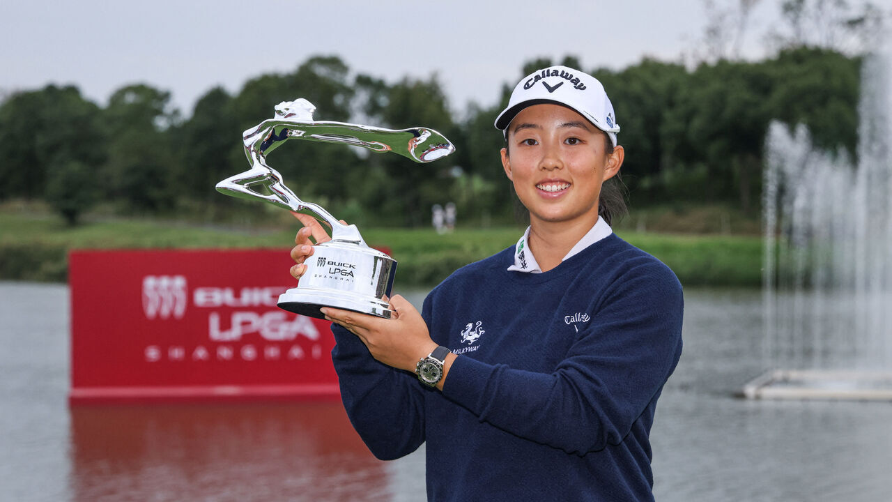 Yin Ruoning of China poses with the trophy after winning the Shanghai LPGA golf tournament in Shanghai on October 13, 2024.