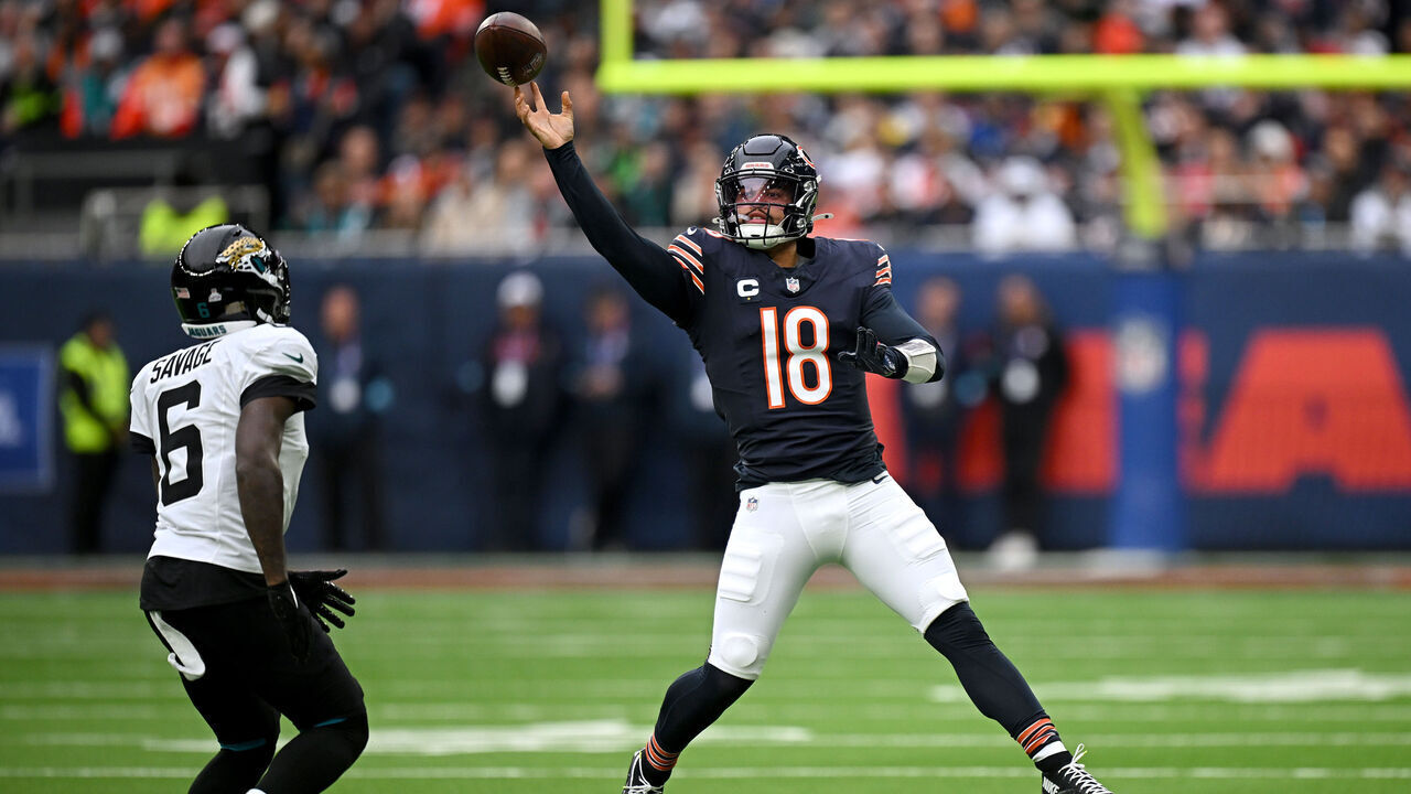 LONDON, ENGLAND - OCTOBER 13: Caleb Williams of Chicago Bears catches the ball under pressure from Darnell Savage of Jacksonville Jaguars during the NFL match between Jacksonville Jaguars and Chicago Bears at Tottenham Hotspur Stadium on October 13, 2024 in London, England.