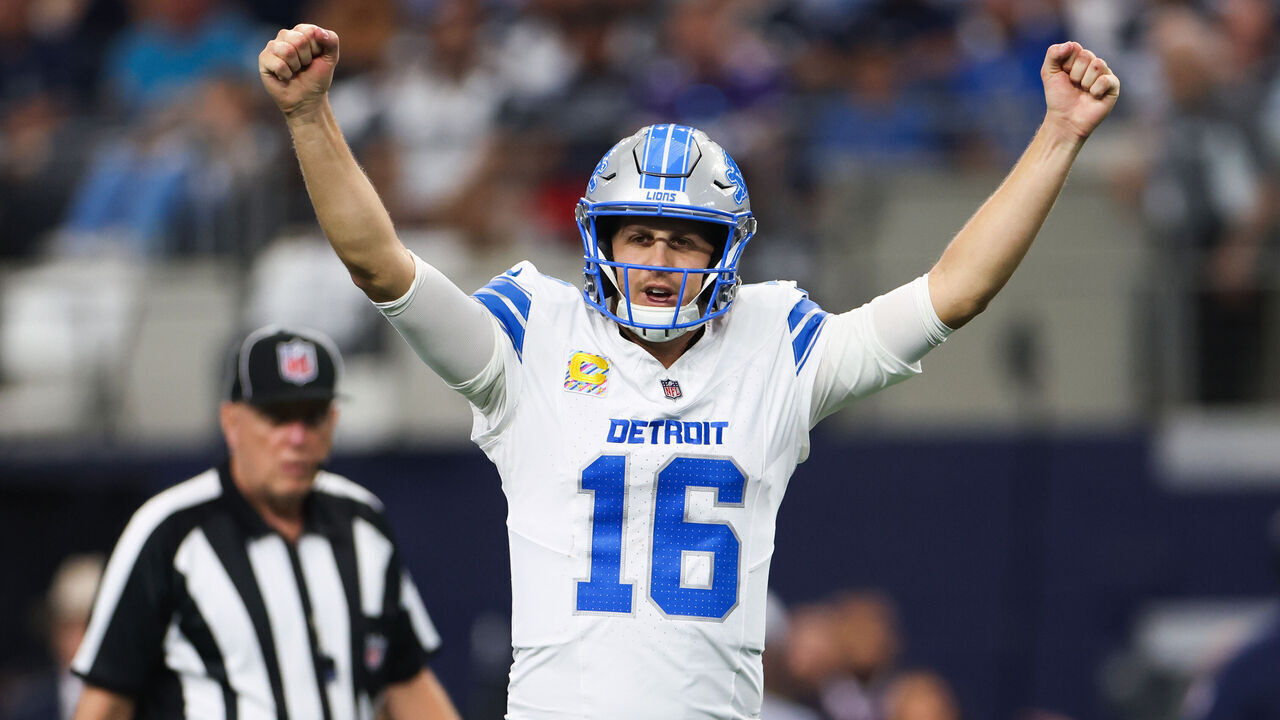 ARLINGTON, TEXAS - OCTOBER 13: Jared Goff #16 of the Detroit Lions reacts after a touchdown in the second quarter of a game against the Dallas Cowboys at AT&T Stadium on October 13, 2024 in Arlington, Texas.