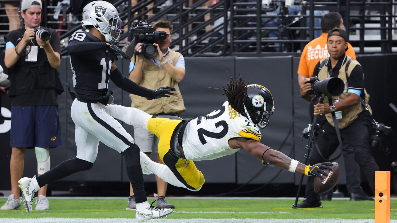 LAS VEGAS, NEVADA - OCTOBER 13: Najee Harris #22 of the Pittsburgh Steelers dives for a touchdown against Jack Jones #18 of the Las Vegas Raiders in the third quarter of a game at Allegiant Stadium on October 13, 2024 in Las Vegas, Nevada.