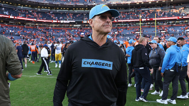 DENVER, COLORADO - OCTOBER 13: Head coach Jim Harbaugh of the Los Angeles Chargers on the field following their 23-16 win against the Denver Broncos at Empower Field At Mile High on October 13, 2024 in Denver, Colorado.