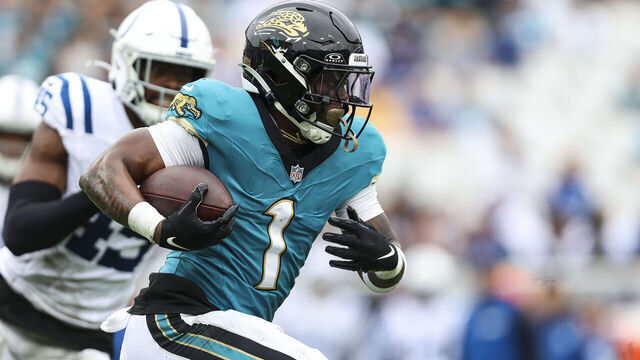 JACKSONVILLE, FLORIDA - OCTOBER 06: Travis Etienne Jr. #1 of the Jacksonville Jaguars runs with the ball during an NFL football game against the Indianapolis Colts at EverBank Stadium on October 6, 2024 in Jacksonville, Florida.