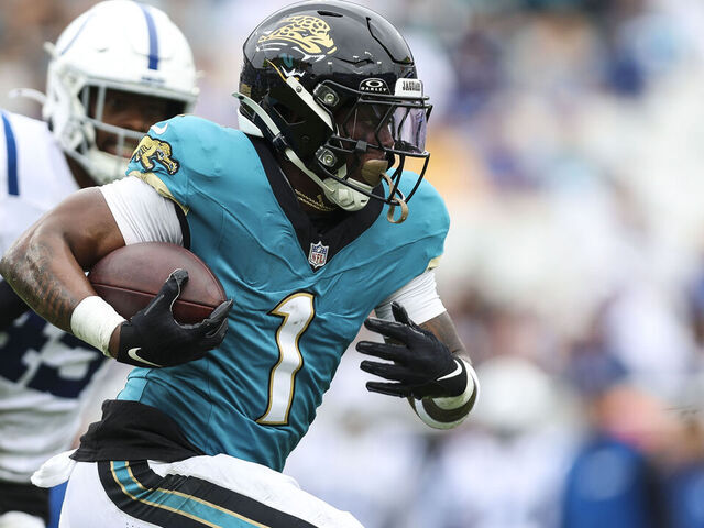 JACKSONVILLE, FLORIDA - OCTOBER 06: Travis Etienne Jr. #1 of the Jacksonville Jaguars runs with the ball during an NFL football game against the Indianapolis Colts at EverBank Stadium on October 6, 2024 in Jacksonville, Florida.