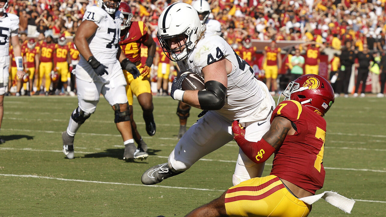 LOS ANGELES, CALIFORNIA - OCTOBER 12: Tyler Warren #44 of the Penn State Nittany Lions catches a pass and is tackled by Kamari Ramsey #7 of the USC Trojans during the fourth quarter at United Airlines Field at the Los Angeles Memorial Coliseum on October 12, 2024 in Los Angeles, California.