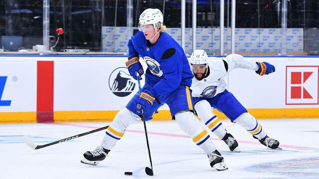 PRAGUE, CZECH REPUBLIC - OCTOBER 03: Rasmus Dahlin #26 of the Buffalo Sabres skates the puck away from Jordan Greenway #12 of the Buffalo Sabres during practice prior to the 2024 NHL Global Series Czechia at O2 Arena on October 03, 2024 in Prague, Czech Republic.