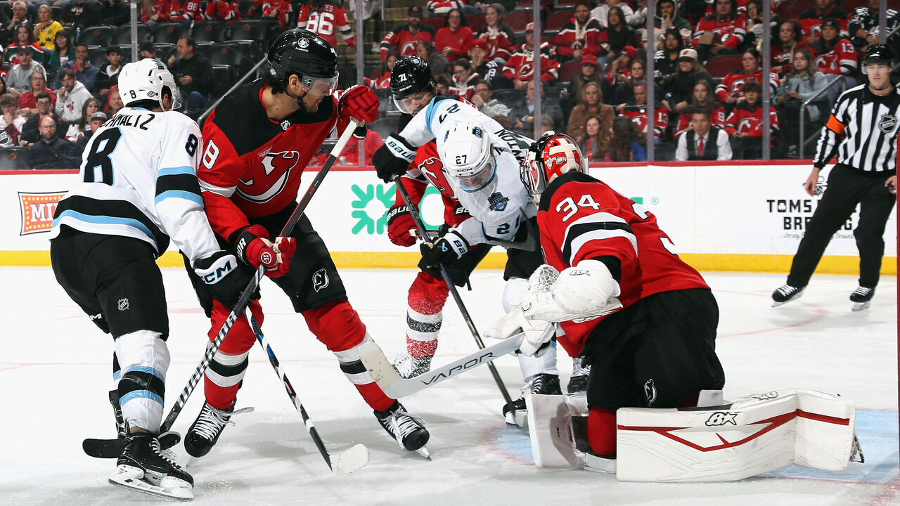 NEWARK, NEW JERSEY - OCTOBER 14: Jake Allen #34 of the New Jersey Devils makes a third period save on Barrett Hayton #27 of Utah Hockey Club at Prudential Center on October 14, 2024 in Newark, New Jersey.