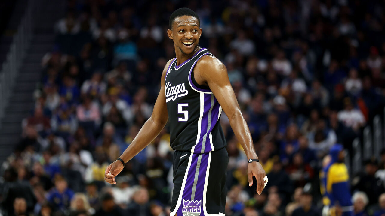 SAN FRANCISCO, CALIFORNIA - OCTOBER 11: De'Aaron Fox #5 of the Sacramento Kings smiles during the first half of their preseason game against the Golden State Warriors at Chase Center on October 11, 2024 in San Francisco, California. NOTE TO USER: User expressly acknowledges and agrees that, by downloading and/or using this photograph, user is consenting to the terms and conditions of the Getty Images License Agreement.