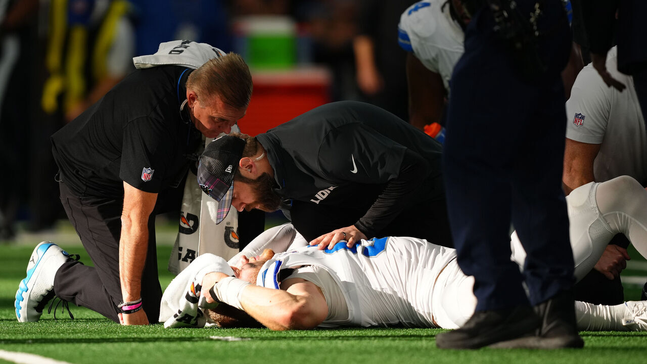 ARLINGTON, TEXAS - OCTOBER 13: Aidan Hutchinson #97 of the Detroit Lions is tended to by medical staff after injuring his leg while recording a sack on Dak Prescott #4 of the Dallas Cowboys in the third quarter of a game at AT&T Stadium on October 13, 2024 in Arlington, Texas.