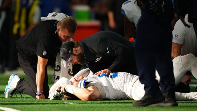 ARLINGTON, TEXAS - OCTOBER 13: Aidan Hutchinson #97 of the Detroit Lions is tended to by medical staff after injuring his leg while recording a sack on Dak Prescott #4 of the Dallas Cowboys in the third quarter of a game at AT&T Stadium on October 13, 2024 in Arlington, Texas.