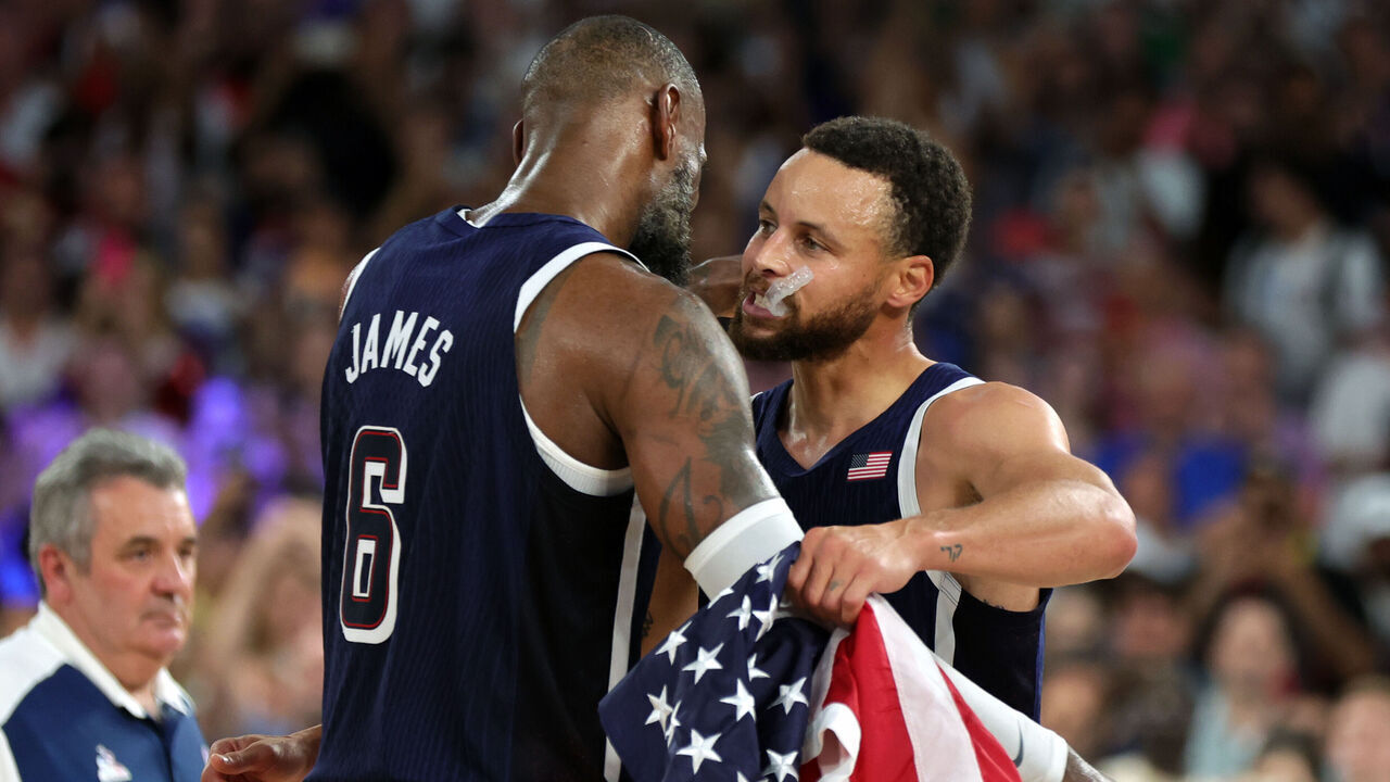 PARIS, FRANCE - AUGUST 10: LeBron James of Team United States celebrates with Stephen Curry of United States after their team's victory during the Men's Gold Medal game between Team France and Team United States on day fifteen of the Olympic Games Paris 2024 at Bercy Arena on August 10, 2024 in Paris, France.