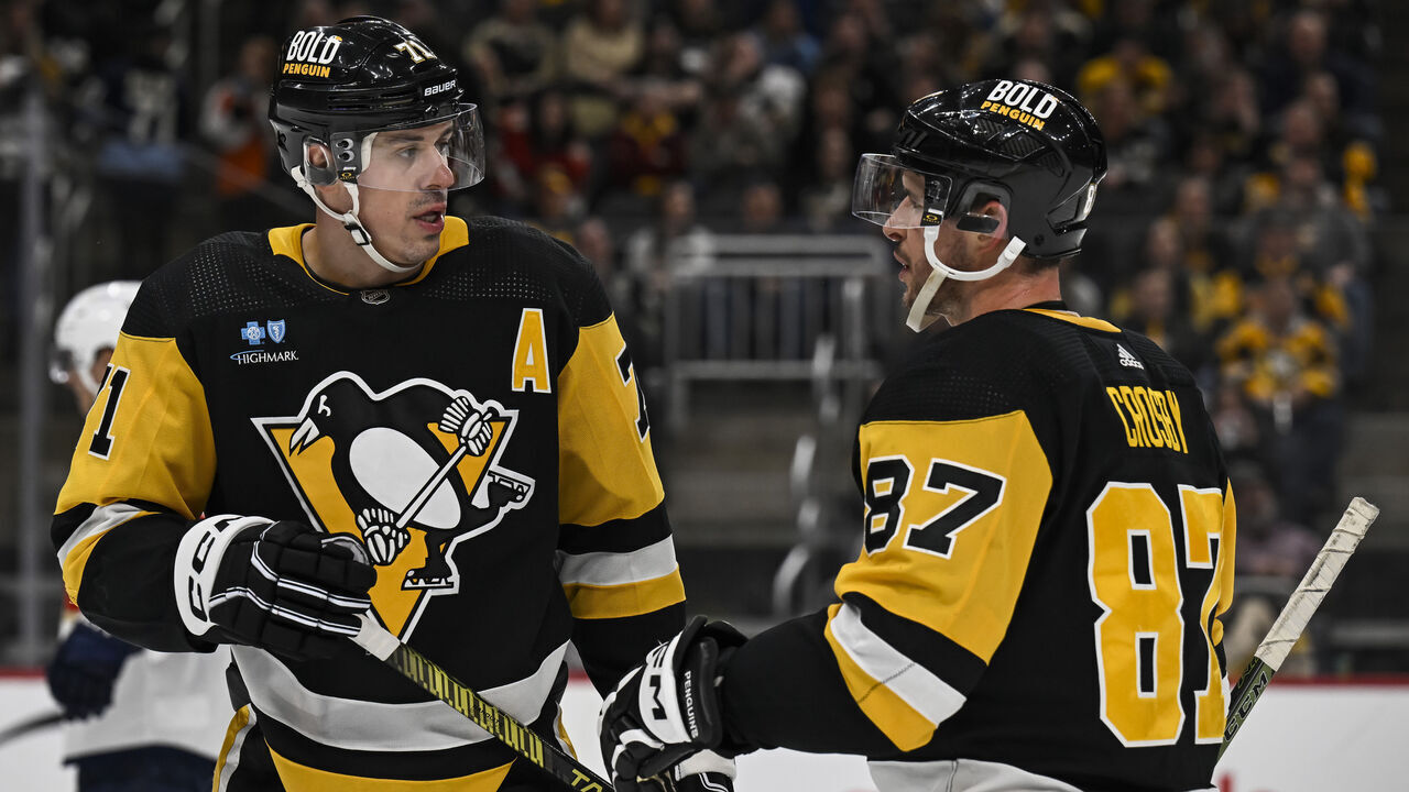 PITTSBURGH, PA - JANUARY 26: Pittsburgh Penguins center Evgeni Malkin (71) and Pittsburgh Penguins center Sidney Crosby (87) talk during the second period in the NHL game between the Pittsburgh Penguins and the Florida Panthers on January 26, 2024, at PPG Paints Arena in Pittsburgh, PA.