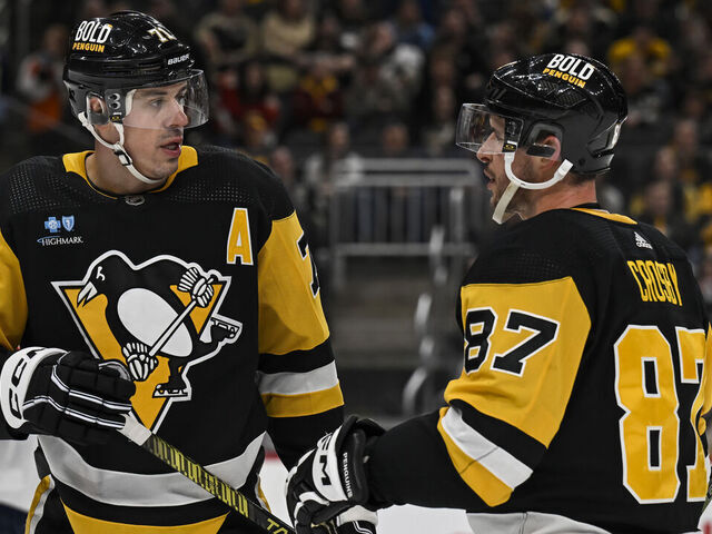 PITTSBURGH, PA - JANUARY 26: Pittsburgh Penguins center Evgeni Malkin (71) and Pittsburgh Penguins center Sidney Crosby (87) talk during the second period in the NHL game between the Pittsburgh Penguins and the Florida Panthers on January 26, 2024, at PPG Paints Arena in Pittsburgh, PA.