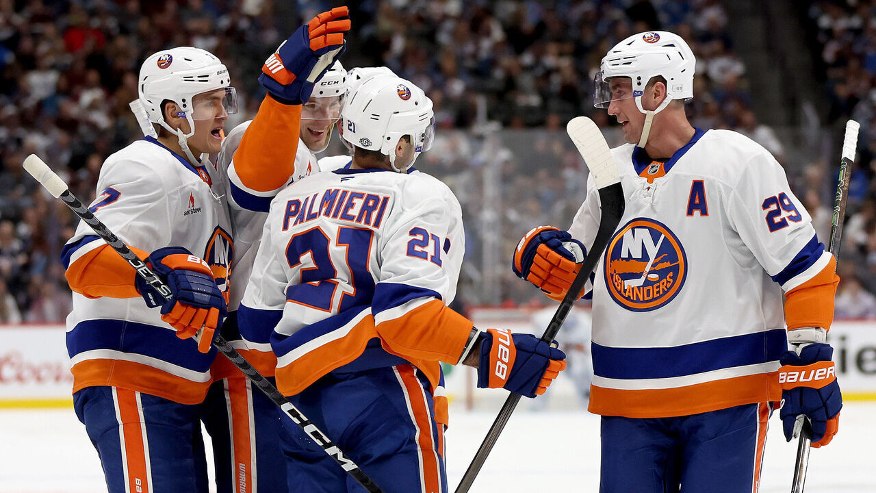 DENVER, COLORADO - OCTOBER 14: Kyle Palmieri #21 of the New York Islanders is congratulated by Maxim Tsyplakov #7, Scott Mayfield #24, Mike Reilly #2 , and Brock Nelson #29 after scoring against the Colorado Avalanche in the first period at Ball Arena on October 14, 2024 in Denver, Colorado.