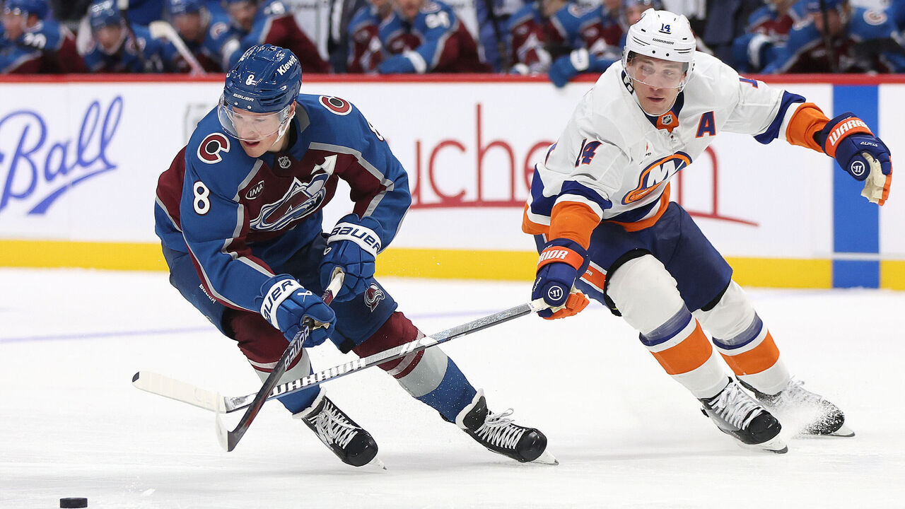DENVER, COLORADO - OCTOBER 14: Cale Makar #8 of the Colorado Avalanche advances the puck against Bo Horvat #14 the New York Islander in the third period at Ball Arena on October 14, 2024 in Denver, Colorado.