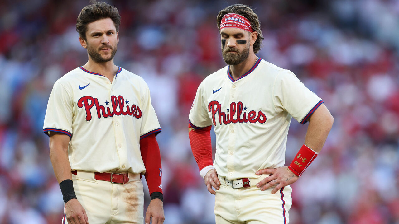 PHILADELPHIA, PA - OCTOBER 05: Trea Turner #7 and Bryce Harper #3 of the Philadelphia Phillies look on in the third inning during Game 1 of the Division Series presented by Booking.com between the New York Mets and the Philadelphia Phillies at Citizens Bank Park on Saturday, October 5, 2024 in Philadelphia, Pennsylvania.