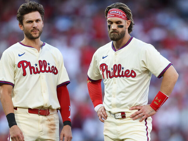 PHILADELPHIA, PA - OCTOBER 05: Trea Turner #7 and Bryce Harper #3 of the Philadelphia Phillies look on in the third inning during Game 1 of the Division Series presented by Booking.com between the New York Mets and the Philadelphia Phillies at Citizens Bank Park on Saturday, October 5, 2024 in Philadelphia, Pennsylvania.