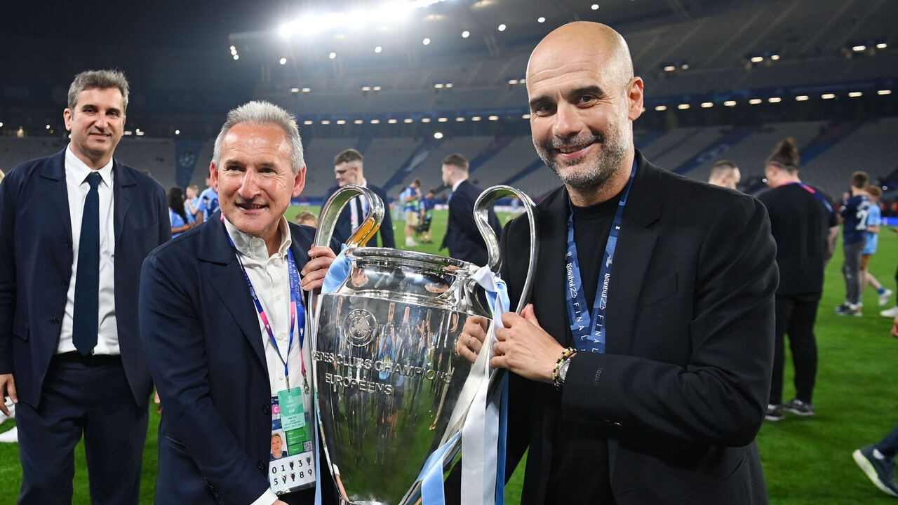 ISTANBUL, TURKEY - JUNE 10: Manchester City director of football Txiki Begiristain and Manchester City manager Pep Guardiola pose with the trophy during the UEFA Champions League 2022/23 final match between FC Internazionale and Manchester City FC at Ataturk Olympic Stadium on June 10, 2023 in Istanbul, Turkey.