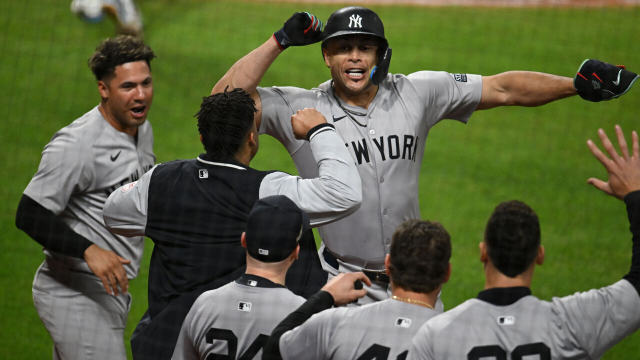 CLEVELAND, OHIO - OCTOBER 17: Giancarlo Stanton #27 of the New York Yankees celebrates a home run with teammates during the eighth inning against the Cleveland Guardians during Game Three of the American League Championship Series at Progressive Field on October 17, 2024 in Cleveland, Ohio.