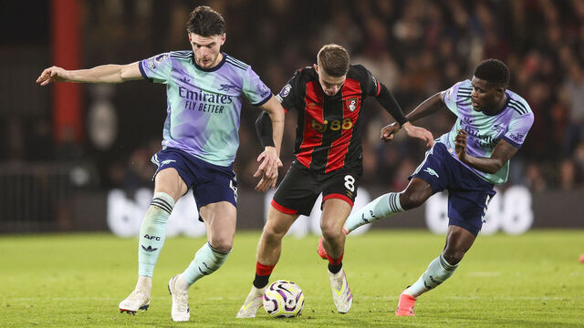 BOURNEMOUTH, ENGLAND - OCTOBER 19: Alex Scott of Bournemouth holds off Declan Rice and Thomas Partey of Arsenal during the Premier League match between AFC Bournemouth and Arsenal FC at Vitality Stadium on October 19, 2024 in Bournemouth, England.