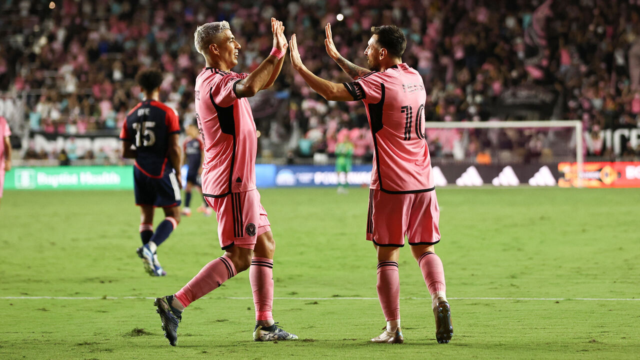 Inter Miami's Argentine forward #10 Lionel Messi celebrates with Uruguayan forward #09 Luis Suarez after scoring his team's fifth goal during the Major League Soccer (MLS) football match between Inter Miami and New England Revolution at Chase Stadium in Fort Lauderdale, Florida, October 19, 2024.