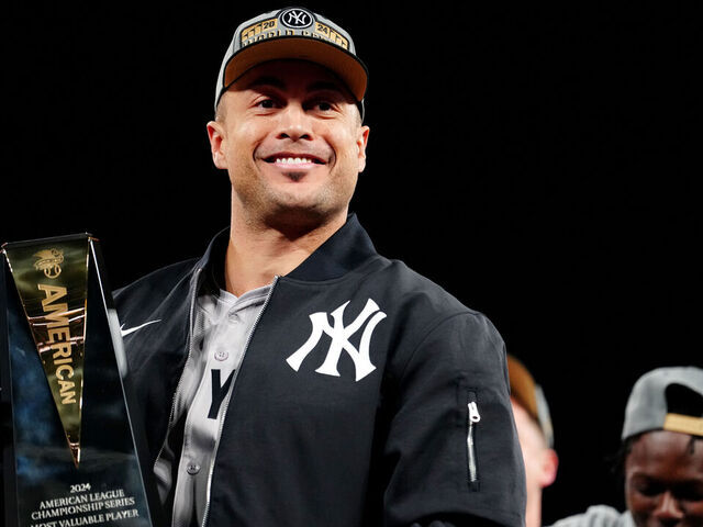 CLEVELAND, OH - OCTOBER 19: Giancarlo Stanton #27 of the New York Yankees poses with the 2024 ALCS MVP Award after the Yankees defeated the Cleveland Guardians in Game 5 of the ALCS presented by loanDepot at Progressive Field on Saturday, October 19, 2024 in Cleveland, Ohio.