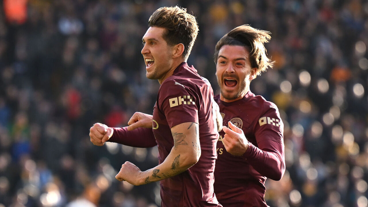WOLVERHAMPTON, ENGLAND - OCTOBER 20: John Stones of Manchester City celebrates scoring his team's second goal with teammate Jack Grealish during the Premier League match between Wolverhampton Wanderers FC and Manchester City FC at Molineux on October 20, 2024 in Wolverhampton, England.