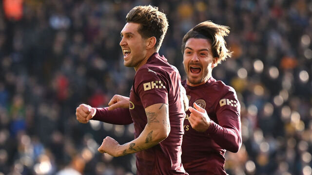 WOLVERHAMPTON, ENGLAND - OCTOBER 20: John Stones of Manchester City celebrates scoring his team's second goal with teammate Jack Grealish during the Premier League match between Wolverhampton Wanderers FC and Manchester City FC at Molineux on October 20, 2024 in Wolverhampton, England.