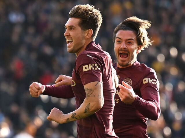 WOLVERHAMPTON, ENGLAND - OCTOBER 20: John Stones of Manchester City celebrates scoring his team's second goal with teammate Jack Grealish during the Premier League match between Wolverhampton Wanderers FC and Manchester City FC at Molineux on October 20, 2024 in Wolverhampton, England.