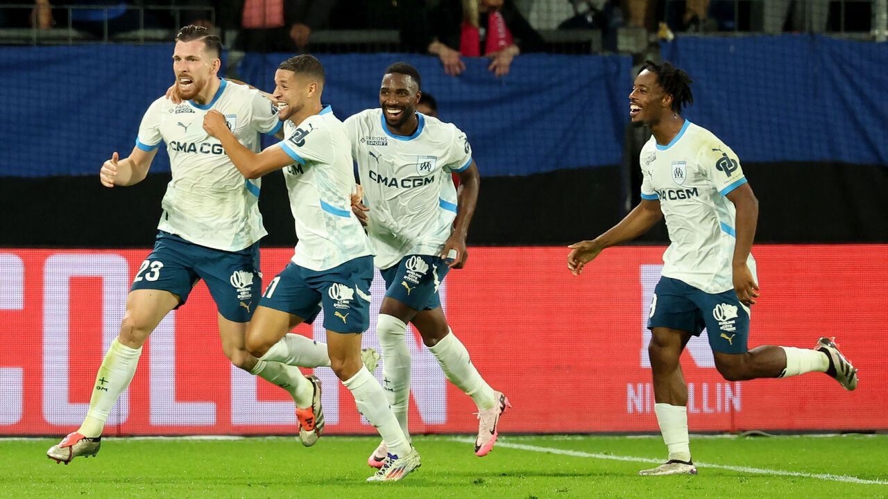 Marseille's Danish midfielder #23 Pierre-Emile Hojbjerg (L) celebrates with teammates after scoring his team's third goal during the French L1 football match between Montpellier Herault SC and Marseille (OM) at La Mosson stadium in Montpellier, southern France on October 20, 2024.