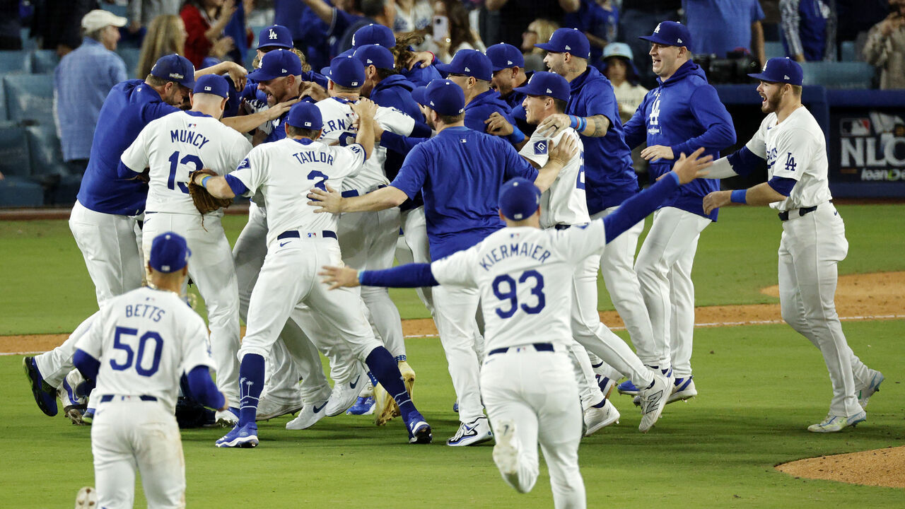 LOS ANGELES, CALIFORNIA - OCTOBER 20: The Los Angeles Dodgers celebrate as they defeat the New York Mets to win Game Six of the National League Championship Series at Dodger Stadium on October 20, 2024 in Los Angeles, California.