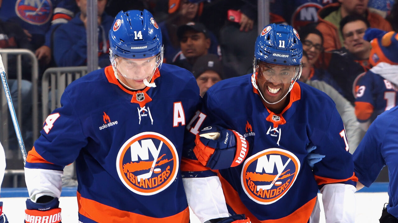 ELMONT, NEW YORK - OCTOBER 19: Bo Horvat #14 of the New York Islanders (L) assists Anthony Duclair #11 off the ice following a third period injury against the Montreal Canadiens at UBS Arena on October 19, 2024 in Elmont, New York.