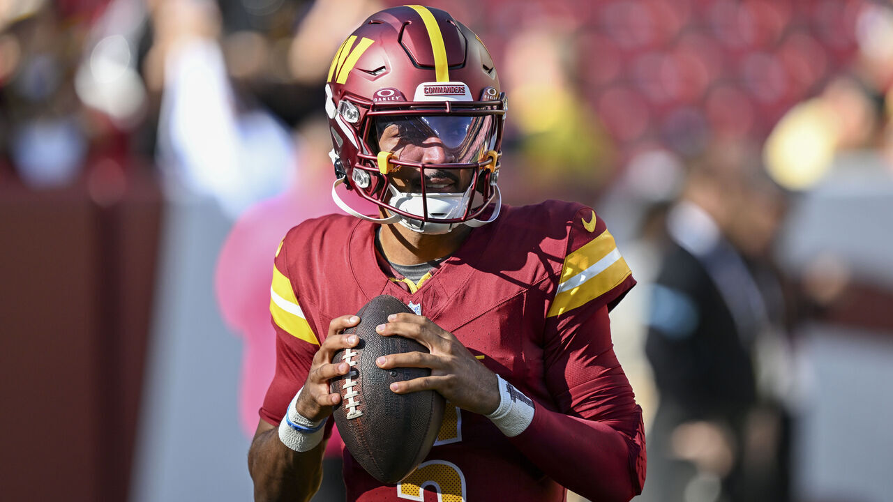 LANDOVER, MARYLAND - OCTOBER 20: Jayden Daniels #5 of the Washington Commanders warms up prior to the game against the Carolina Panthers at Northwest Stadium on October 20, 2024 in Landover, Maryland.