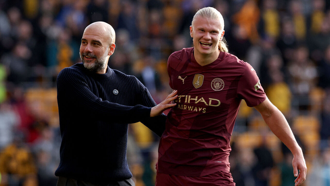 Manchester City's Spanish manager Pep Guardiola and Manchester City's Norwegian striker #09 Erling Haaland react following the English Premier League football match between Wolverhampton Wanderers and Manchester City at the Molineux stadium in Wolverhampton, central England on October 20, 2024.