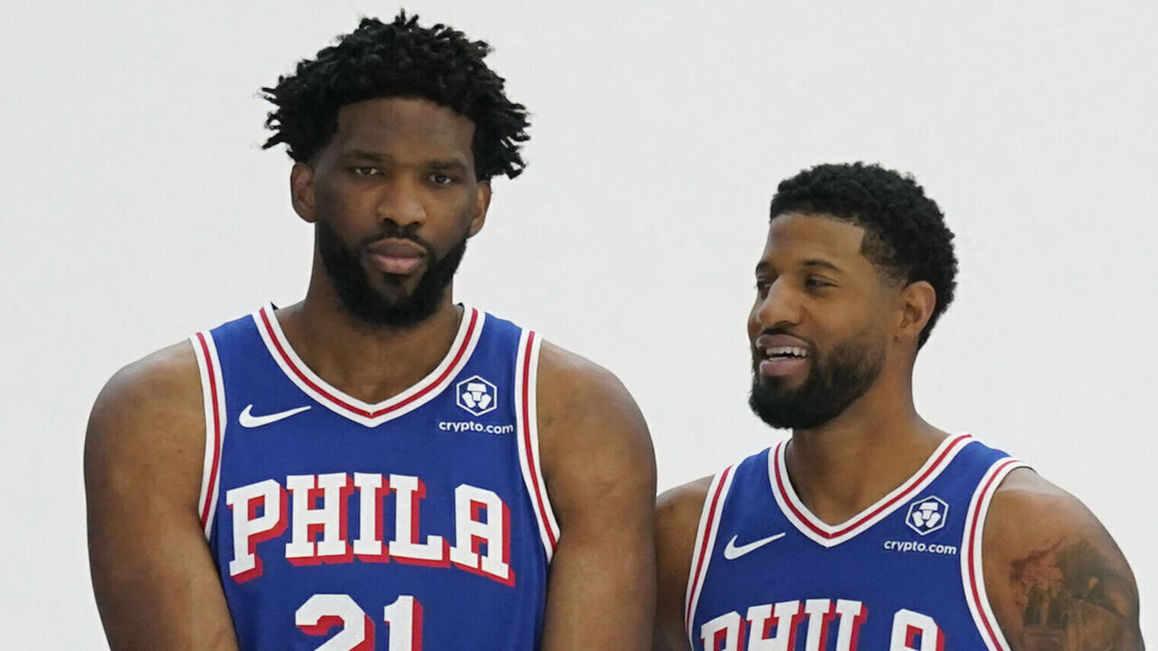 (L-R) Philadelphia 76ers guard Tyrese Maxey, center Joel Embiid and small forward Paul George pose for photos during the 76ers media day ahead of the NBA season at the 76ers Training Complex in Camden, New Jersey, September 30, 2024.