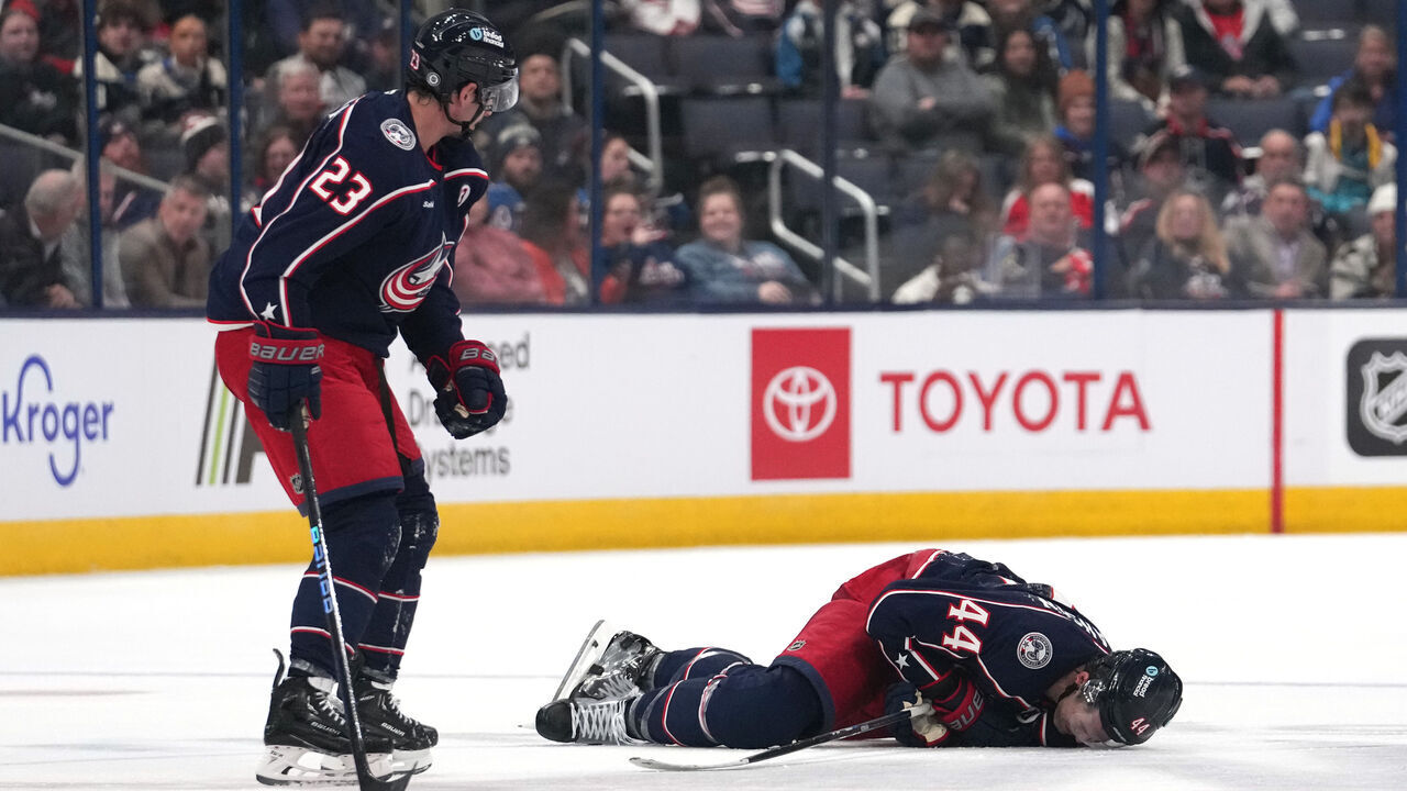 COLUMBUS, OHIO - OCTOBER 15: Erik Gudbranson #44 of the Columbus Blue Jackets lies on the ice after colliding with teammate Sean Monahan #23 during the second period against the Florida Panthers at Nationwide Arena on October 15, 2024 in Columbus, Ohio.