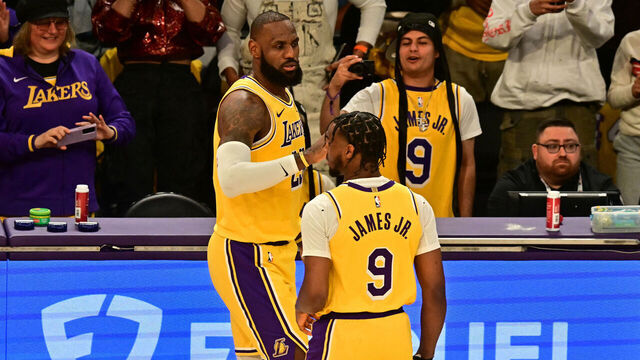 Los Angeles Lakers' US small forward #23 LeBron James (L) and Los Angeles Lakers' US guard #09 Bronny James are seen on court during the NBA game season opener between the Los Angeles Lakers and the Minnesota Timberwolves at Crypto Arena in Los Angeles on October 22, 2024. LeBron and Bronny are the first father and son to play together in any NBA game.