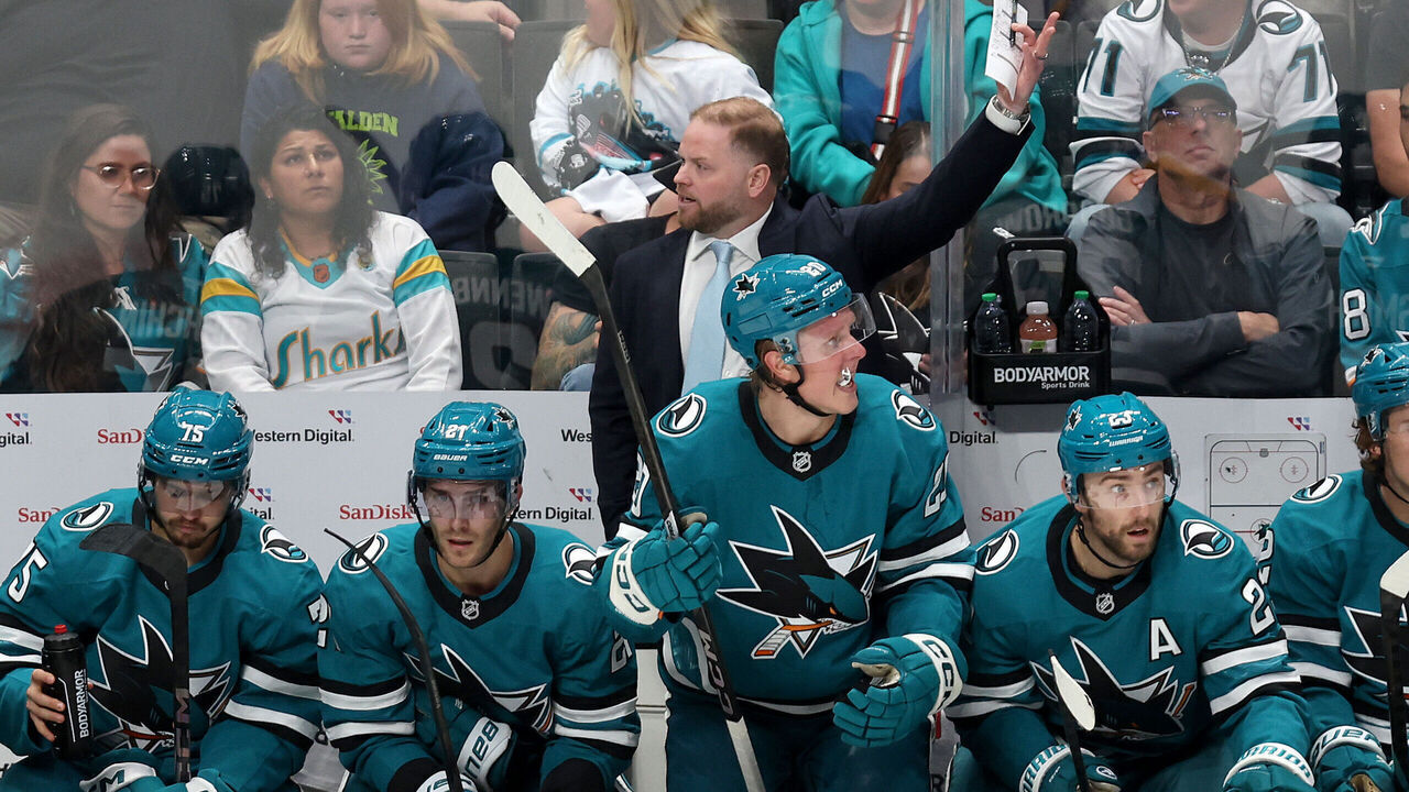 SAN JOSE, CALIFORNIA - OCTOBER 10: San Jose Sharks head coach Ryan Warsofsky stands behind his team on the bench during their game against the St. Louis Blues at SAP Center on October 10, 2024 in San Jose, California.