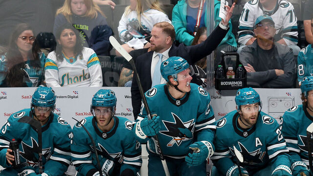 SAN JOSE, CALIFORNIA - OCTOBER 10: San Jose Sharks head coach Ryan Warsofsky stands behind his team on the bench during their game against the St. Louis Blues at SAP Center on October 10, 2024 in San Jose, California.